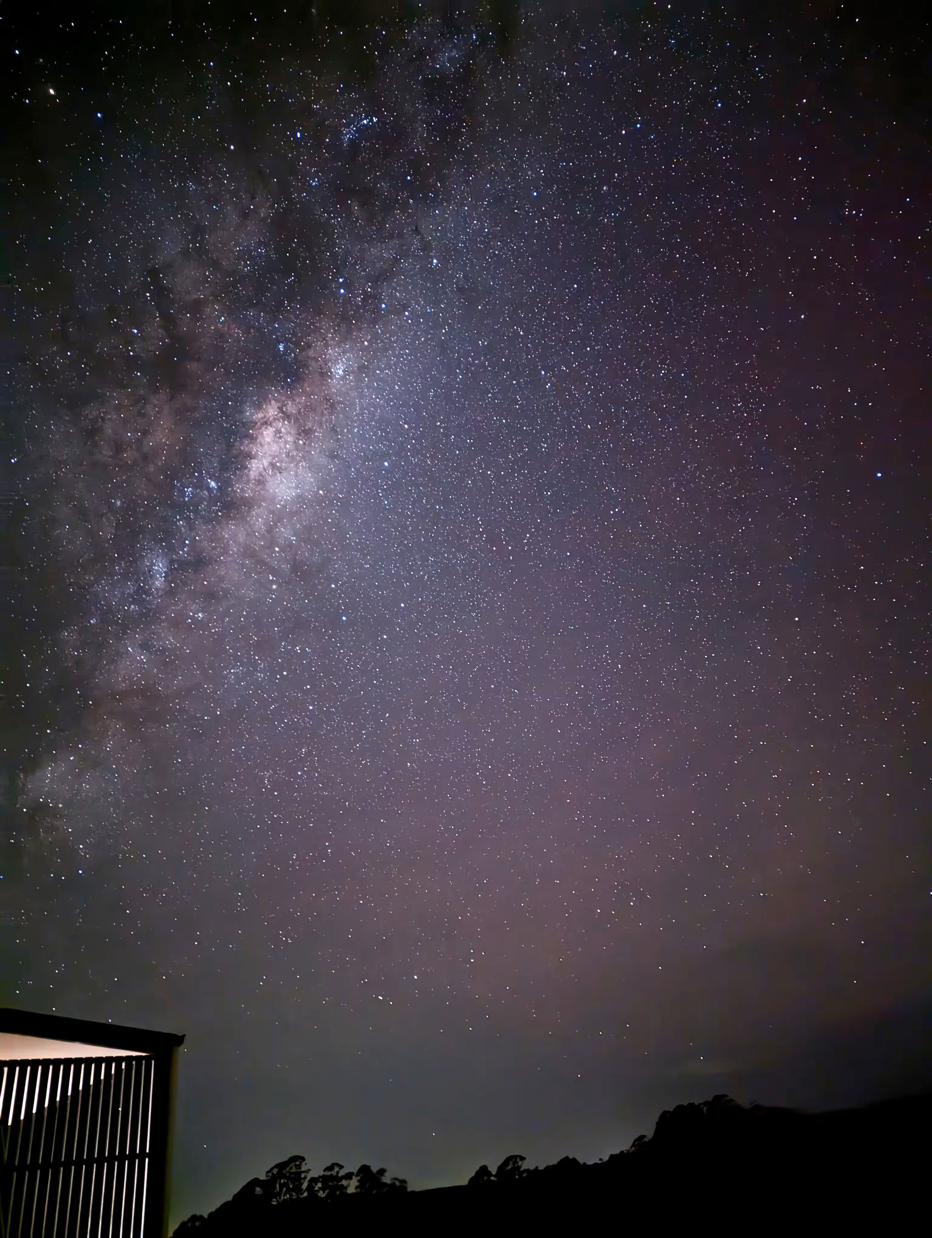 A streak of stars and gas stretch diagonally across a shot of the night sky.